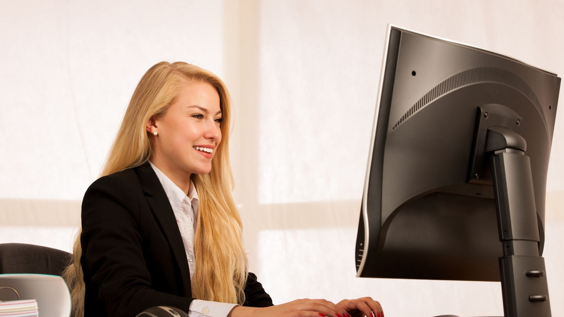 Woman in formal working on computer